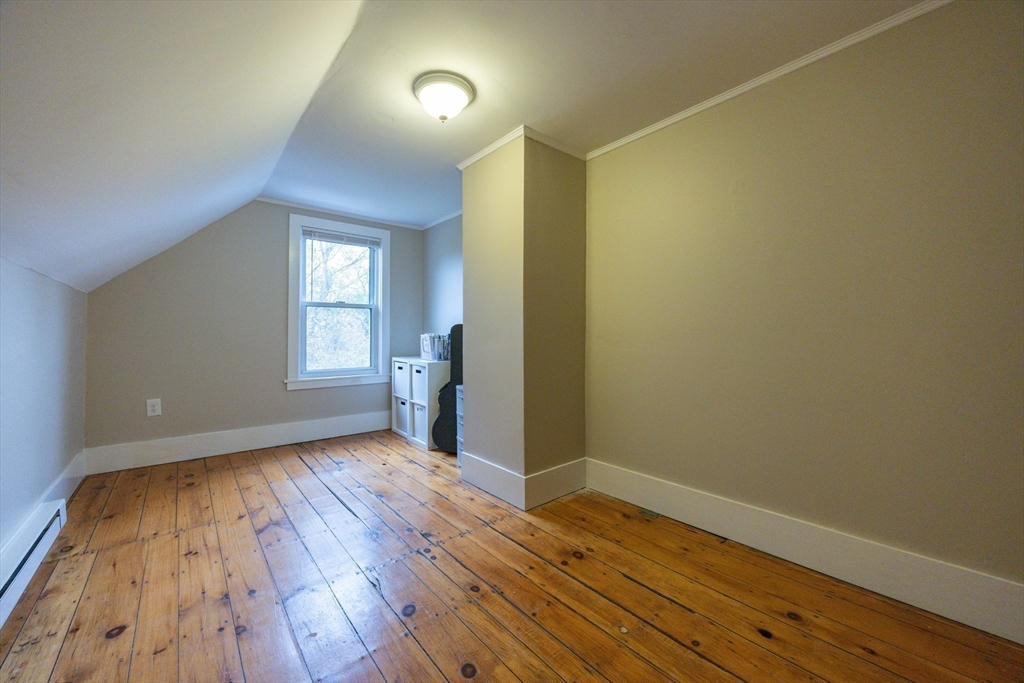12 1st Street, Unit 12 Ipswich, MA 01938 - Photo 35 of 42 an empty room with wooden floor and windows