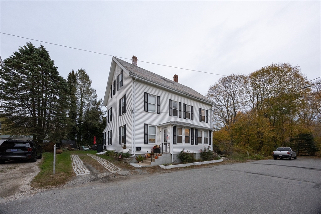 12 1st Street, Unit 12 Ipswich, MA 01938 - Photo 42 of 42 a view of a white house with a large windows and palm trees