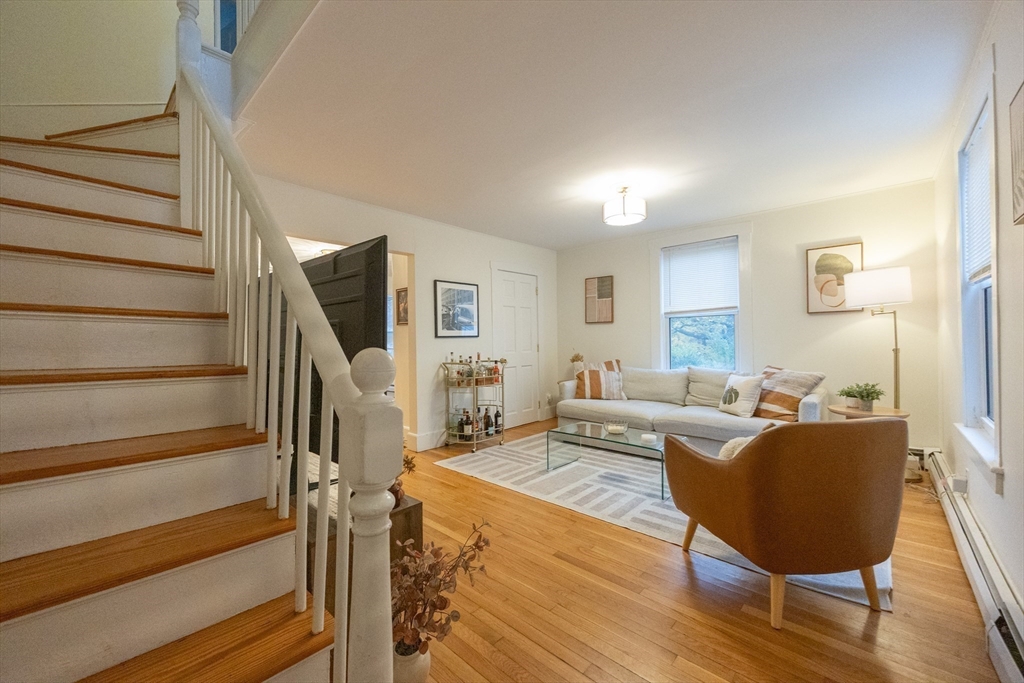 12 1st Street, Unit 12 Ipswich, MA 01938 - Photo 6 of 42 a living room with furniture and a wooden floor