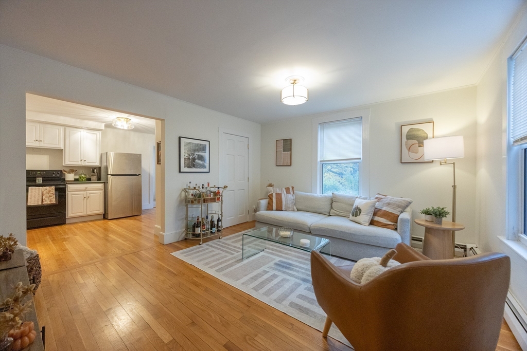 12 1st Street, Unit 12 Ipswich, MA 01938 - Photo 7 of 42 a living room with furniture and kitchen view