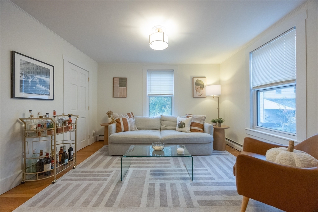 12 1st Street, Unit 12 Ipswich, MA 01938 - Photo 8 of 42 a living room with furniture and a wooden floor