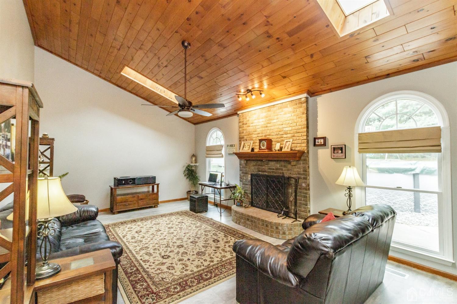 66 Rustic Trail Flemington, NJ 08822 - Photo 14 of 37 a living room with furniture a flat screen tv and a fireplace