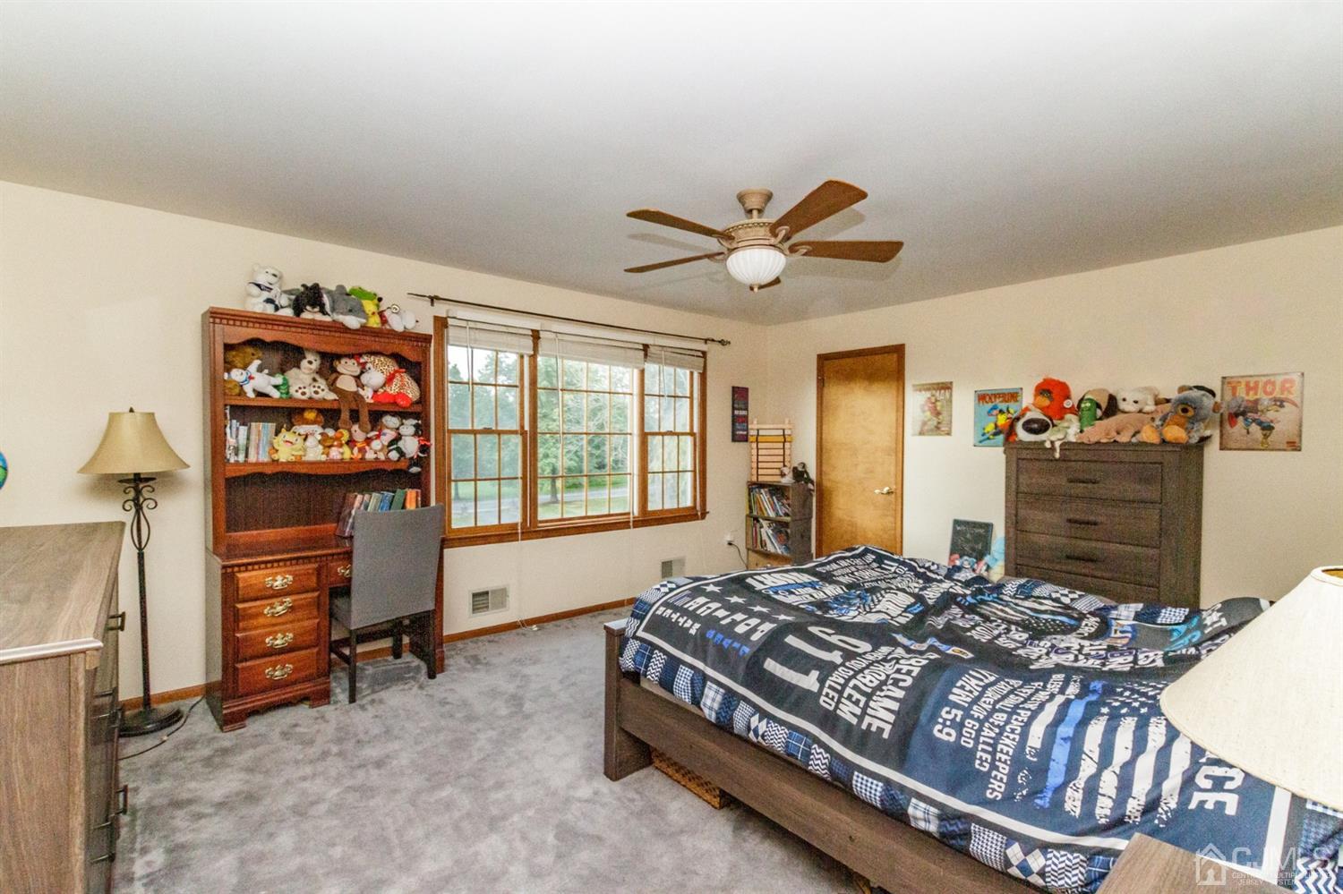 66 Rustic Trail Flemington, NJ 08822 - Photo 29 of 37 a bedroom with a bed a dresser and a large mirror