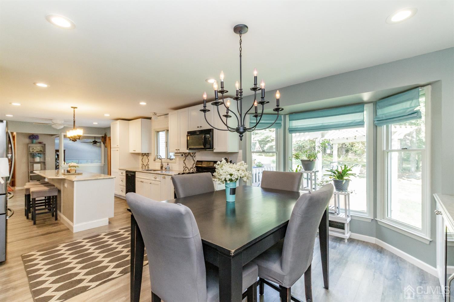 66 Rustic Trail Flemington, NJ 08822 - Photo 10 of 37 a view of a dining room and livingroom with furniture wooden floor a chandelier