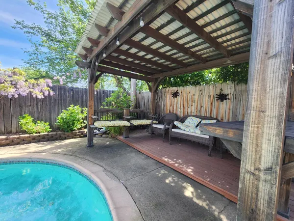 a view of a backyard with sitting area and furniture
