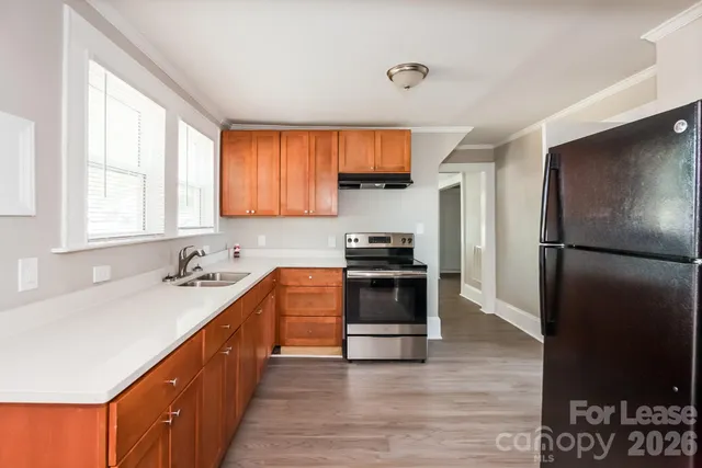 a kitchen with a refrigerator stove and sink