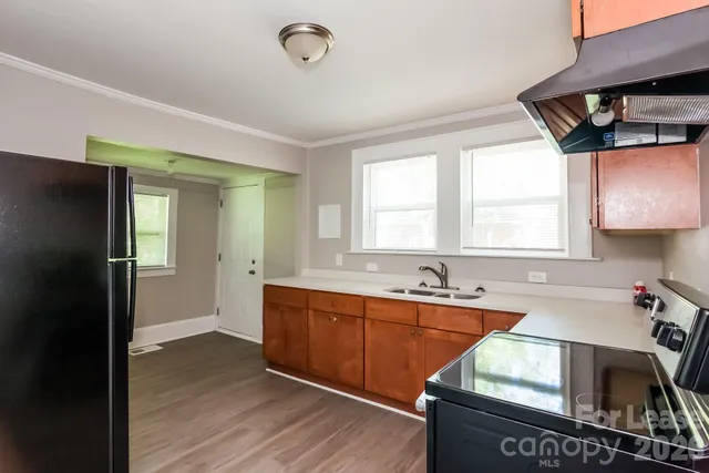 a kitchen that has a sink and a stove in it