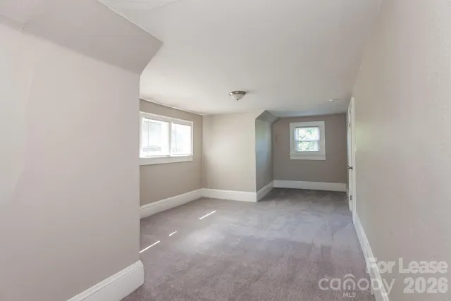 a view of an empty room with windows