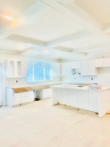 a front view of a house with a garden and trees