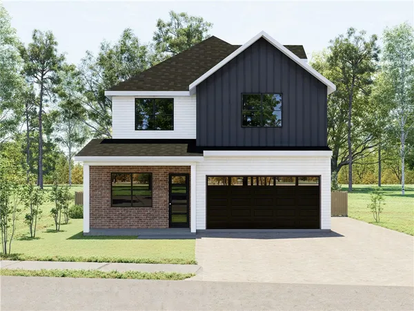a front view of a house with a garden and garage