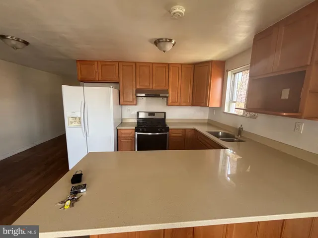 a kitchen with a refrigerator a sink and a stove