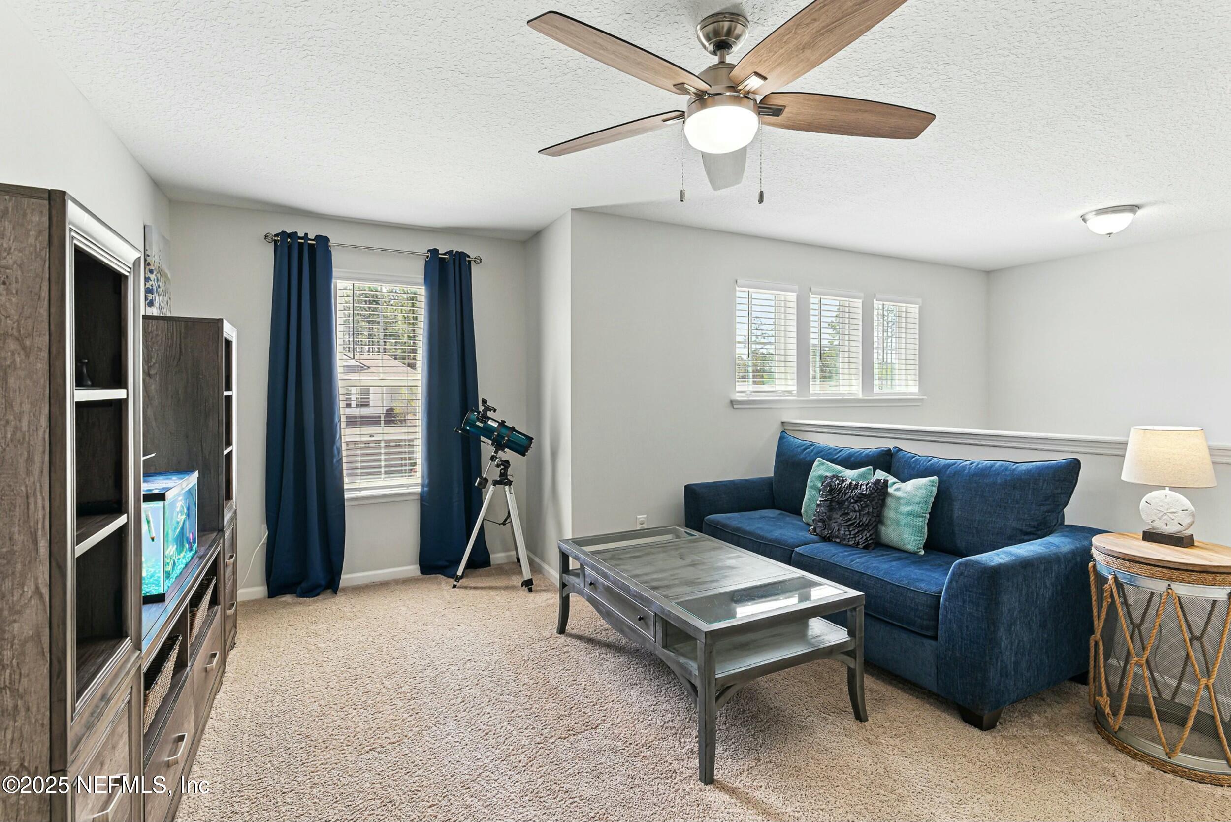 30 Cloverbrook Road St. Johns, FL 32259 - Photo 19 of 69 a living room with furniture a ceiling fan and a window
