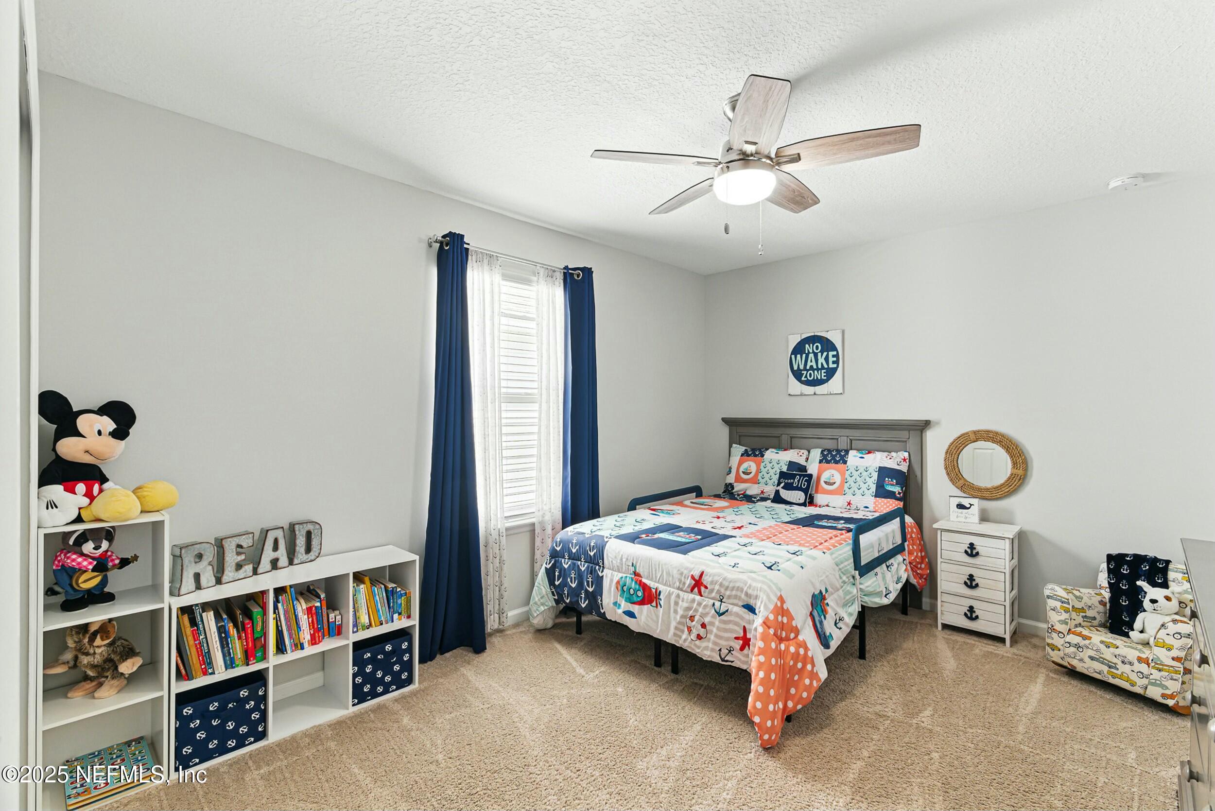 30 Cloverbrook Road St. Johns, FL 32259 - Photo 20 of 69 a bedroom with bed and a book shelf