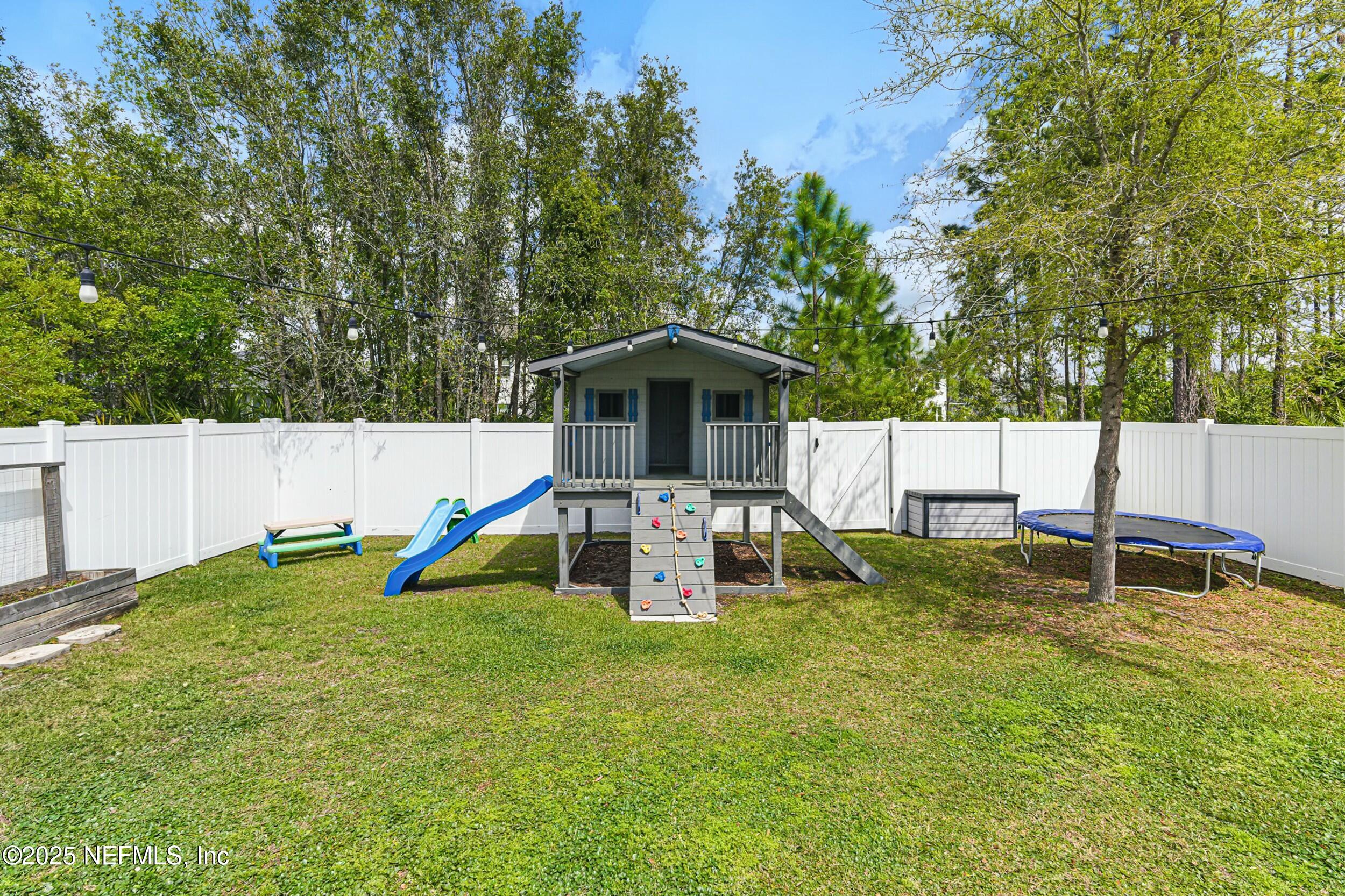 30 Cloverbrook Road St. Johns, FL 32259 - Photo 26 of 69 a backyard of a house with barbeque oven and swing table