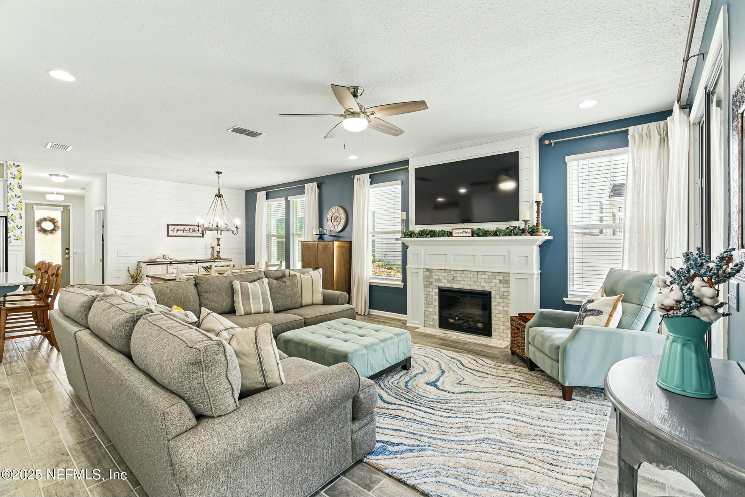 30 Cloverbrook Road St. Johns, FL 32259 - Photo 3 of 69 a living room with furniture a flat screen tv and a fireplace