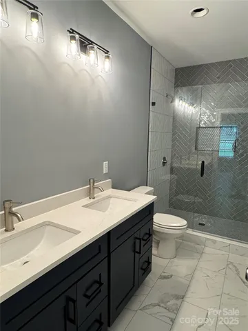 a bathroom with a toilet and a shower