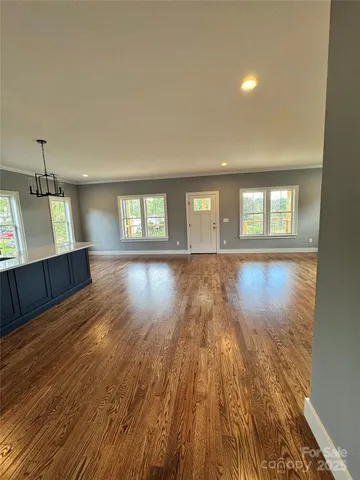 a view of wooden floor and windows in a room