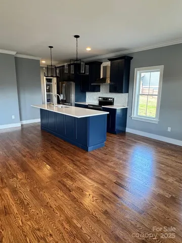 a view of kitchen with sink microwave and cabinets