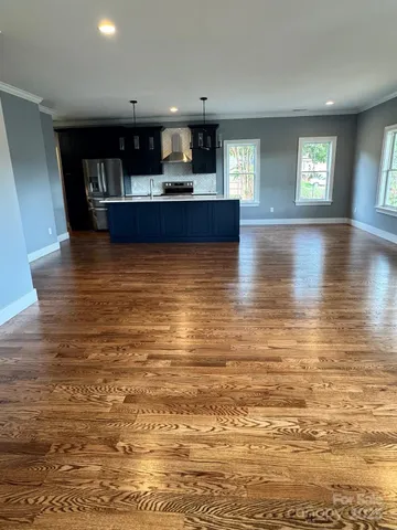a view of kitchen and kitchen with stainless steel appliances