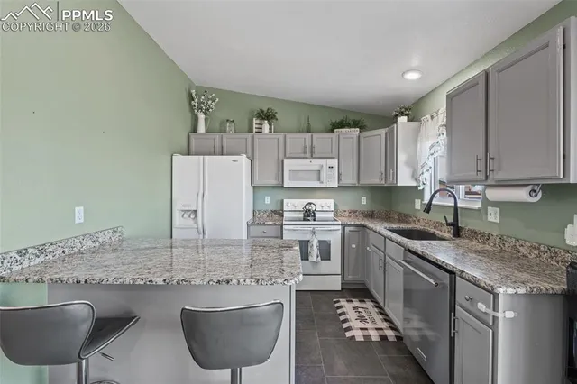 a kitchen with stainless steel appliances granite countertop a sink stove and cabinets