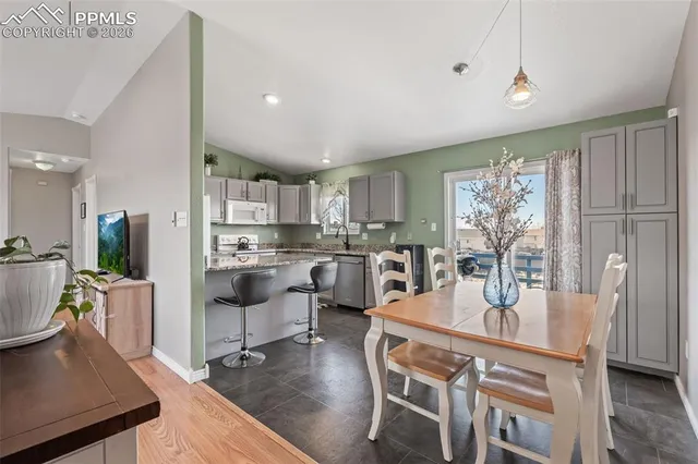 a view of a dining room with furniture and wooden floor