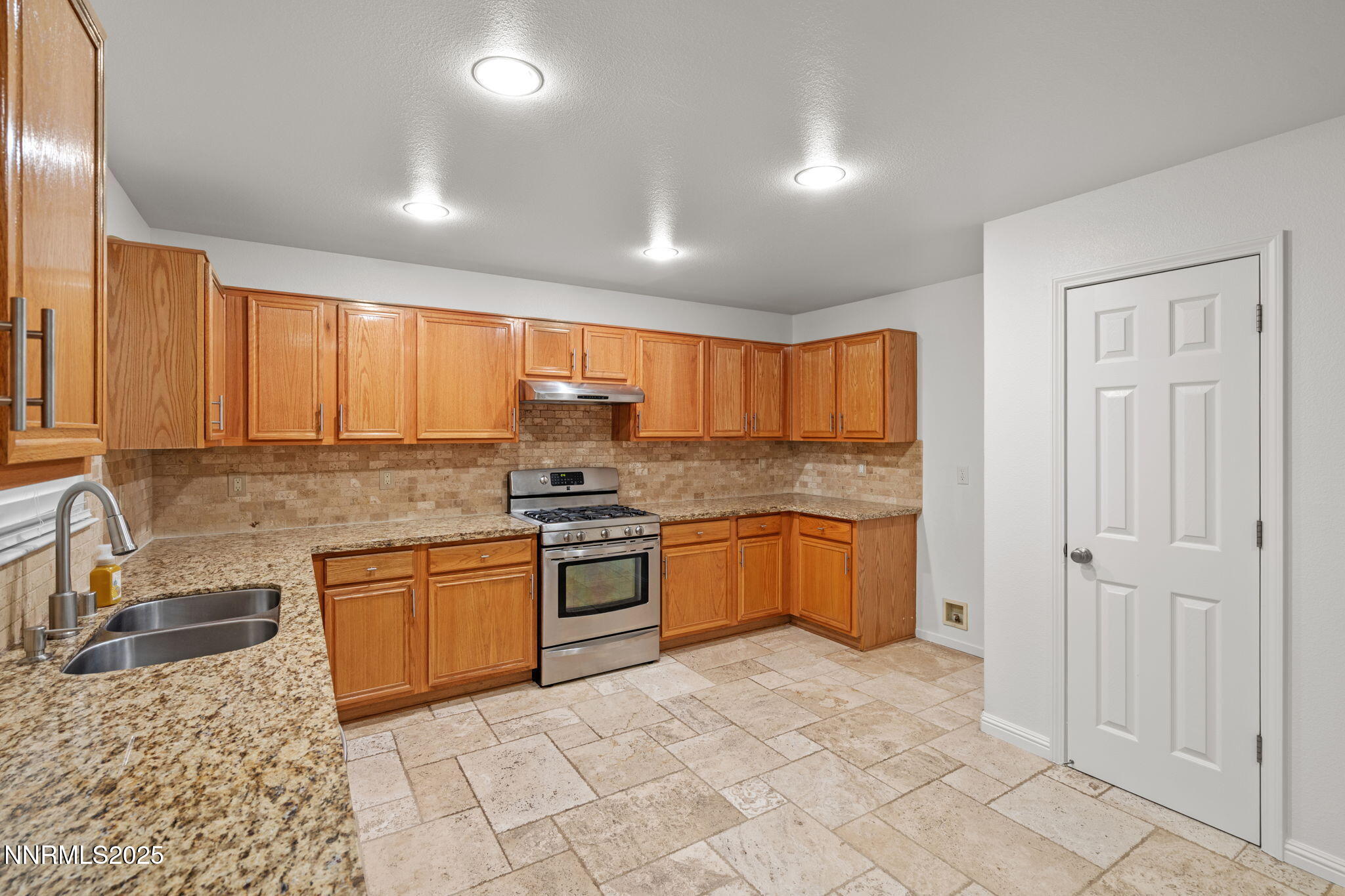 5455 Montego Court Reno, NV 89523 - Photo 14 of 36 a kitchen with stainless steel appliances granite countertop a stove a sink and a refrigerator