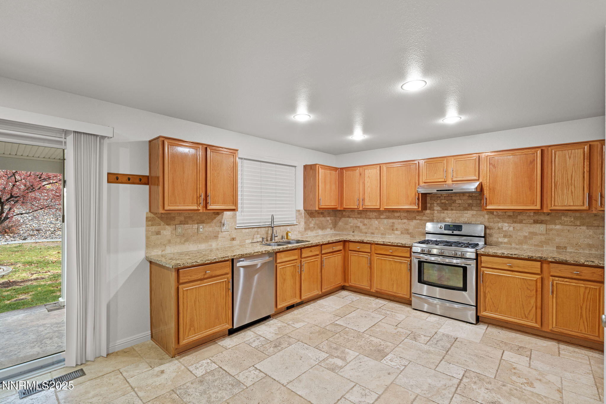 5455 Montego Court Reno, NV 89523 - Photo 15 of 36 a kitchen with stainless steel appliances granite countertop a stove sink and cabinets