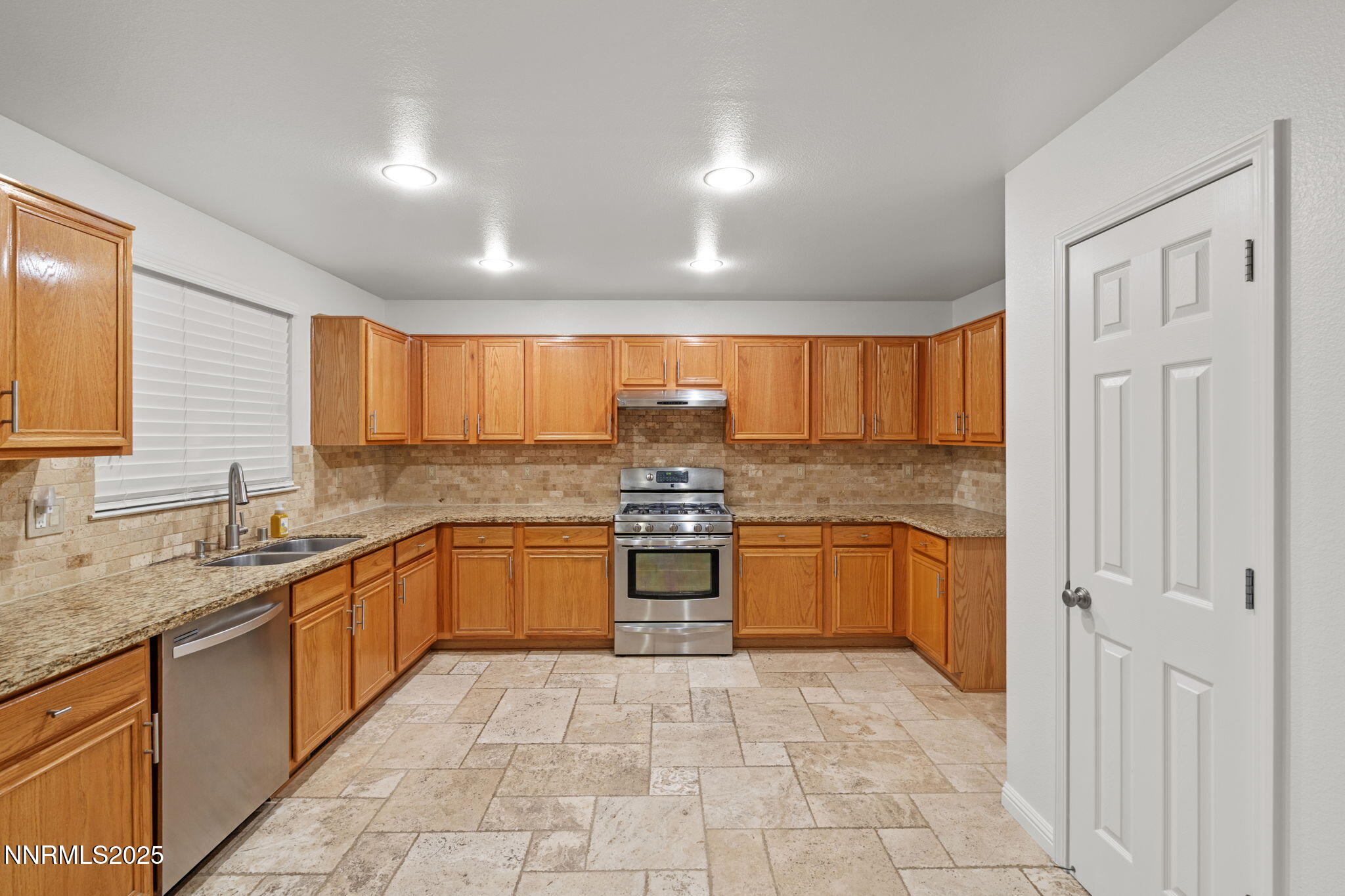 5455 Montego Court Reno, NV 89523 - Photo 16 of 36 a large kitchen with stainless steel appliances granite countertop a stove sink and cabinets