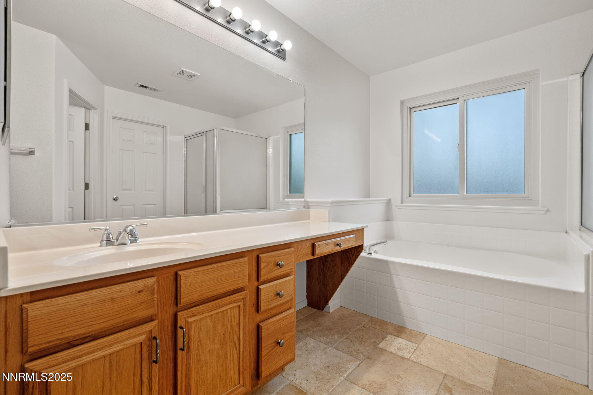 5455 Montego Court Reno, NV 89523 - Photo 23 of 36 a spacious bathroom with a tub sink and mirror