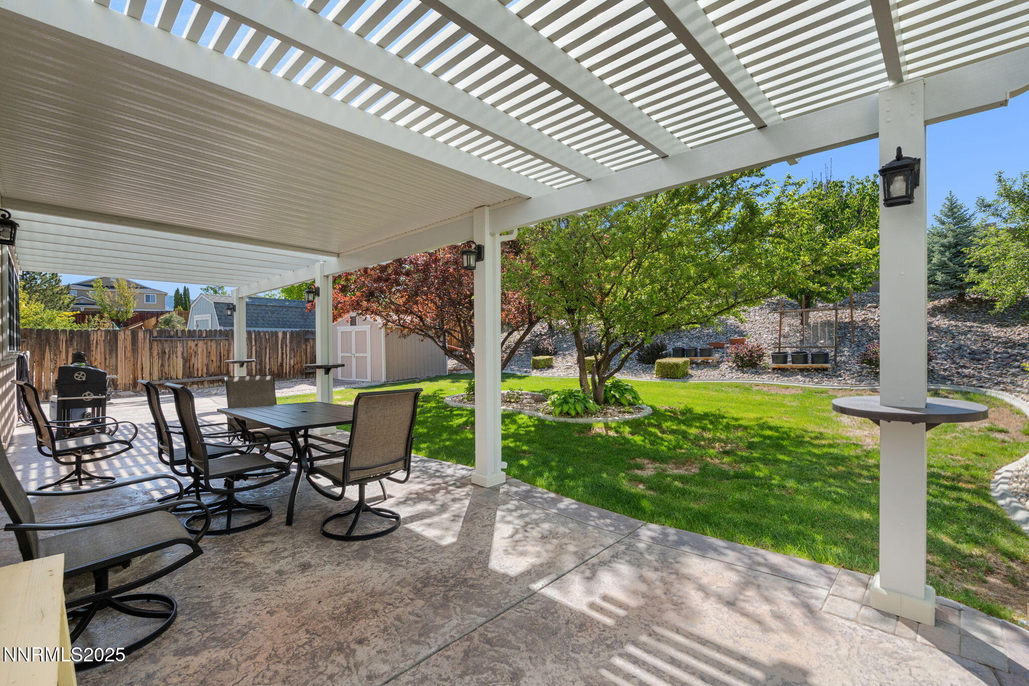 5455 Montego Court Reno, NV 89523 - Photo 29 of 36 a view of a patio with table and chairs potted plants and floor to ceiling window