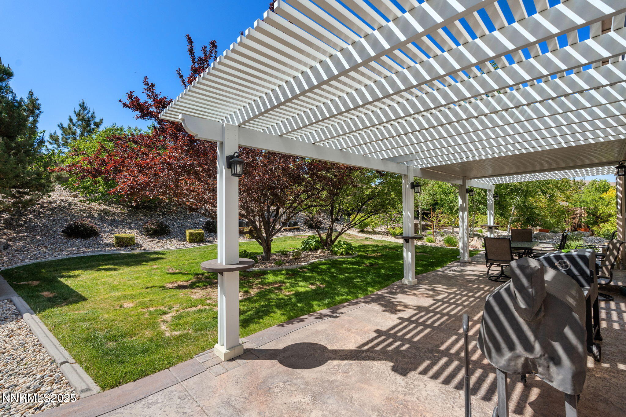 5455 Montego Court Reno, NV 89523 - Photo 30 of 36 a view of a patio with table and chairs potted plants with wooden floor and fence