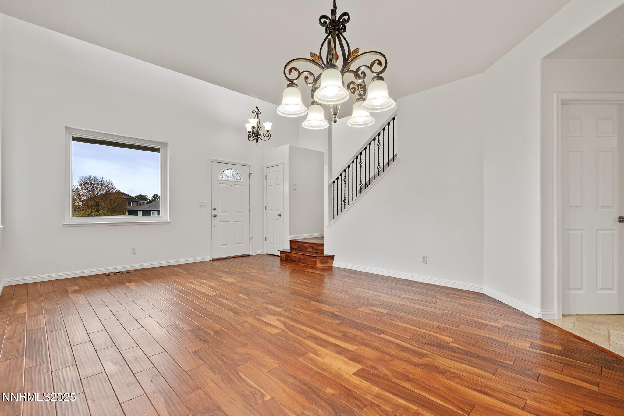 5455 Montego Court Reno, NV 89523 - Photo 5 of 36 a view of an empty room with wooden floor and a chandelier