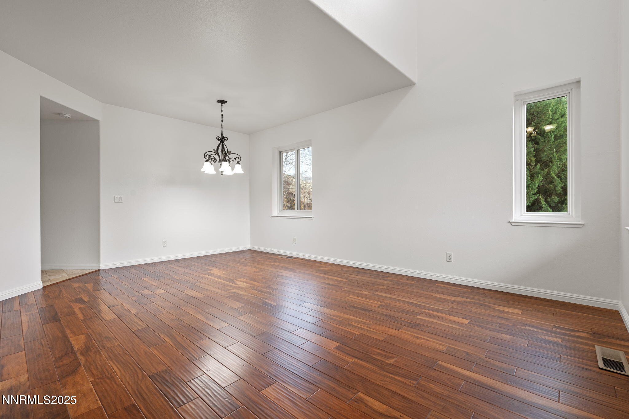 5455 Montego Court Reno, NV 89523 - Photo 6 of 36 an empty room with wooden floor chandelier and windows