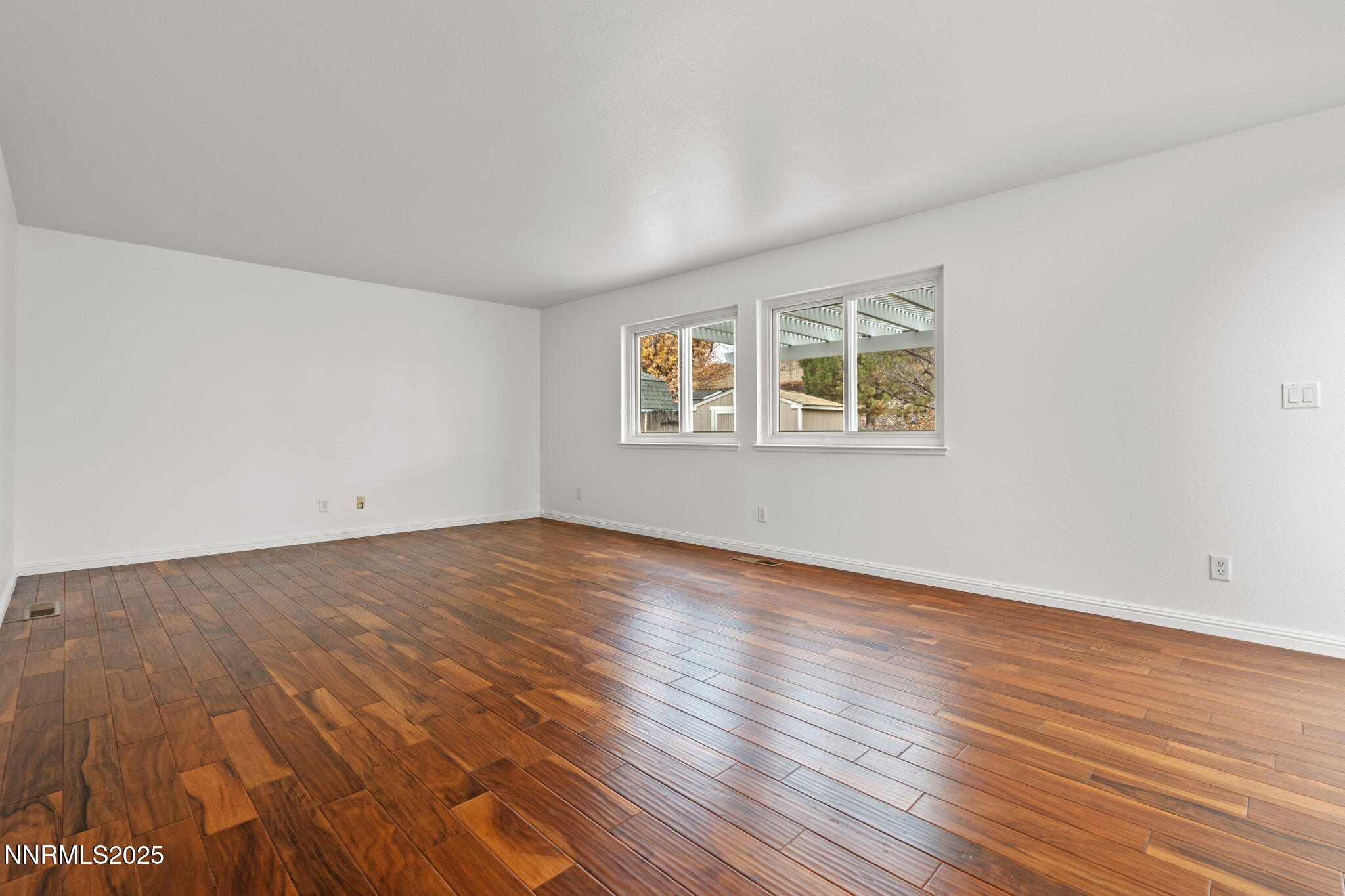 5455 Montego Court Reno, NV 89523 - Photo 7 of 36 an empty room with wooden floor and windows
