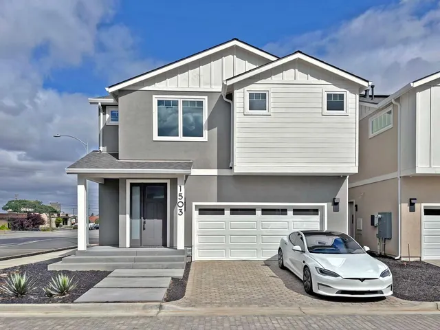 a car parked in front of white house