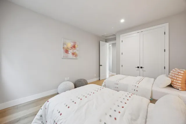 a bedroom with a bed and a painting on the wall