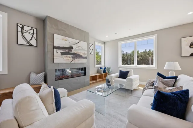 a living room with furniture and a fireplace