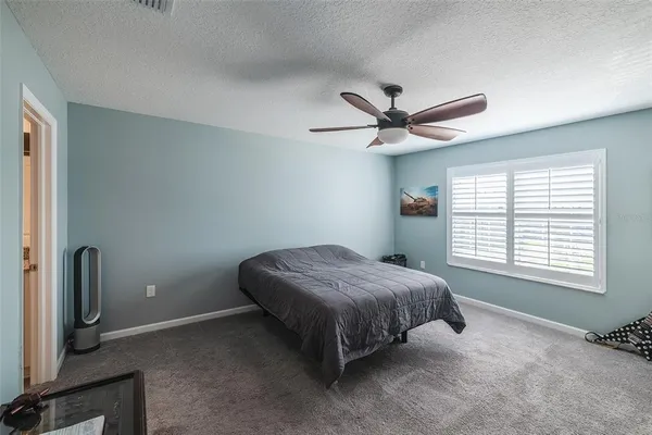 a bed room with a bed and a window