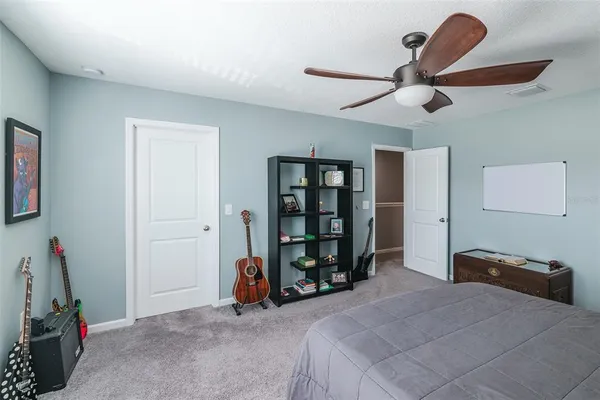 a bedroom with a bed and a book shelf