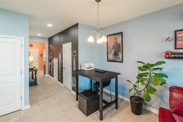 a view of a livingroom with furniture and a potted plant