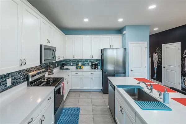 a kitchen with a sink stove and refrigerator