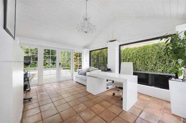 a living room with furniture large window and chairs