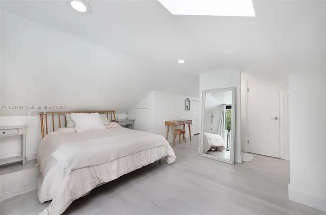 a bedroom with a bed and a lamp