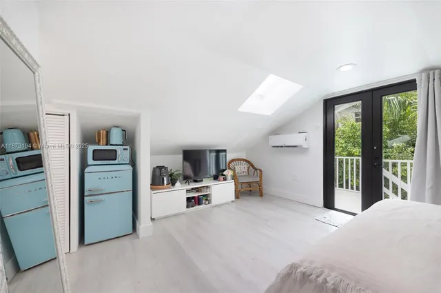 a room with a bed and a large window