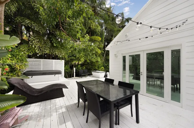 a view of a patio with a table and chairs