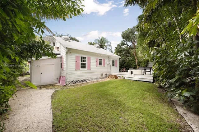 a backyard of a house with table and chairs