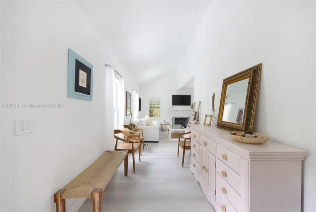 a living room with furniture wooden floor and flat screen tv