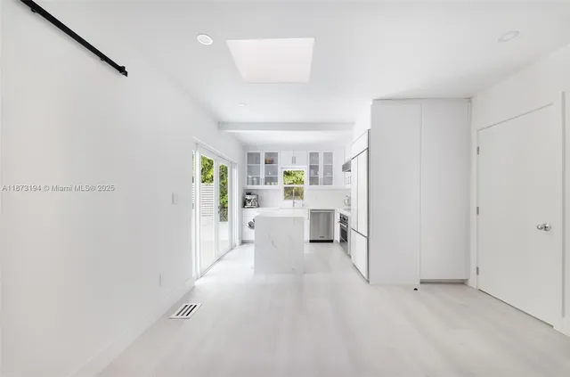 a view of a living room hardwood and a refrigerator