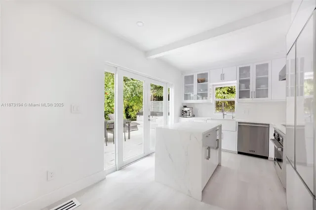 a living room with furniture a white stove next to a window