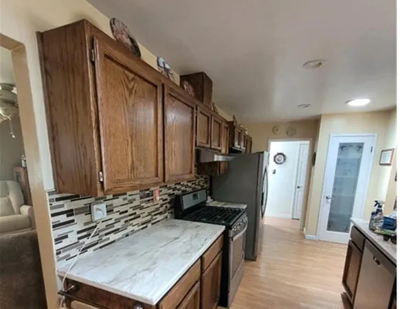 a kitchen with a stove and a refrigerator